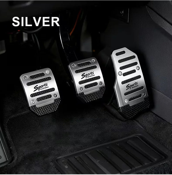 Silver manual anti-slip car pedals shown in a dark interior setting.