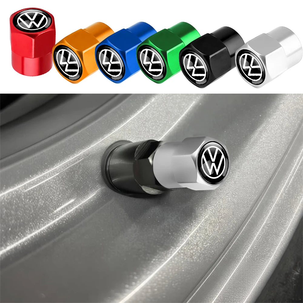 A row of multi-color metal tire valve caps, including red, orange, blue, green, and black, displayed next to a silver cap.