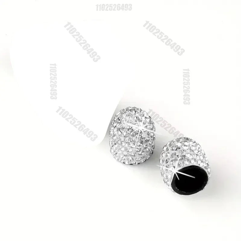 A set of crystal diamond finish tire valve caps with black cores.