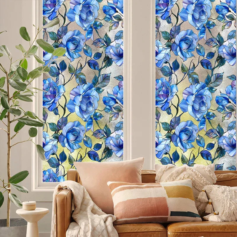 A close-up of a window featuring decorative blue and green floral stained glass patterns.