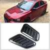 Carbon fiber car hood scoop vent trim for a red vehicle.