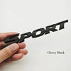 Glossy black 3D chrome car logo emblem for rear trunk being held by a hand