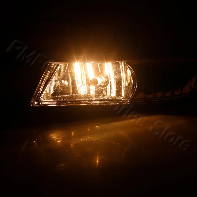 Close-up of an LED fog light assembly with bumper trim illuminated in a dark setting.