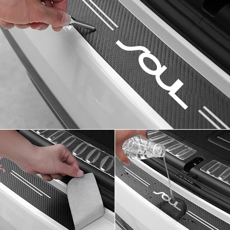 A hand is applying a carbon fiber door sill protector with a custom logo to a vehicle's interior trim.