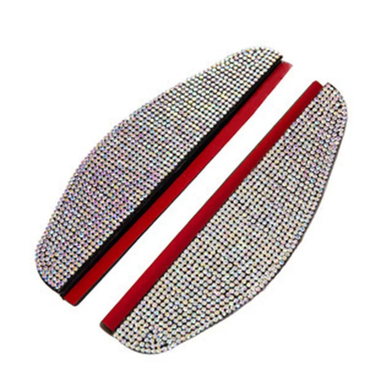 A pair of rhinestone car rain shield visors with red accents shown diagonally.