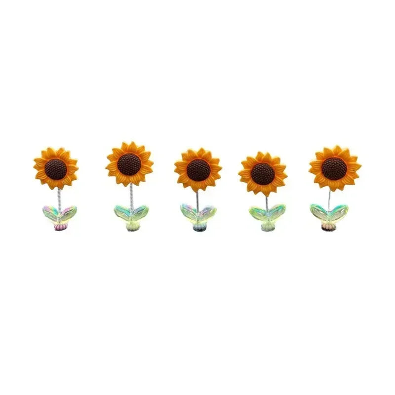 Un ensemble de décorations pour console et miroir en forme de tournesols qui tremblent.