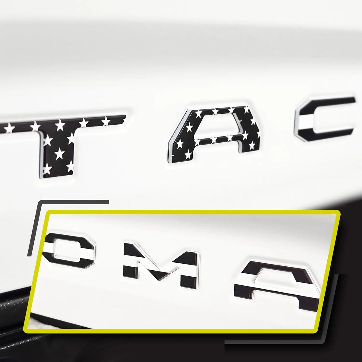 Black and white 3D letter cover emblems for a Toyota Tacoma tailgate.