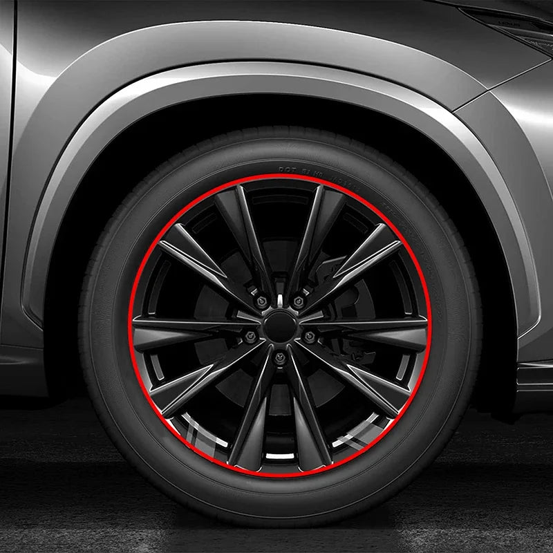Close-up view of a car wheel with a red protective strip highlighting the rim and spokes.