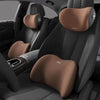 Interior view of a car seat showing three brown neck support pillows for headrests.