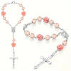 Silver rosary necklace featuring pink rose beads and a cross pendant