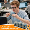 A young man is holding a light-up keyboard fidget toy, which is designed as a keychain for stress relief.
