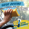 A hand holds a yellow and blue anti-fog cleaning sponge near a car window, with text promoting safer driving.