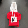 A red hoodie cover with a white hood and black drawstrings is displayed on a dark surface.