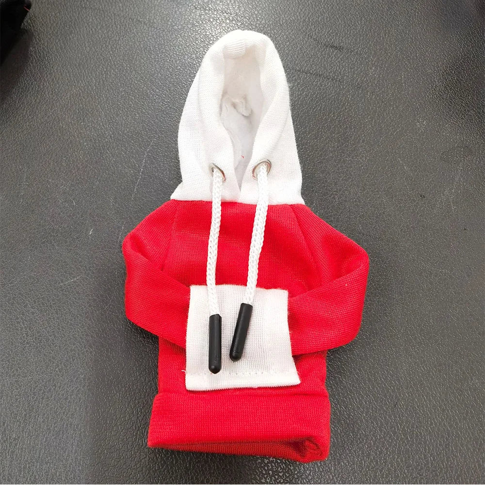 A red hoodie cover with a white hood and black drawstrings is displayed on a dark surface.