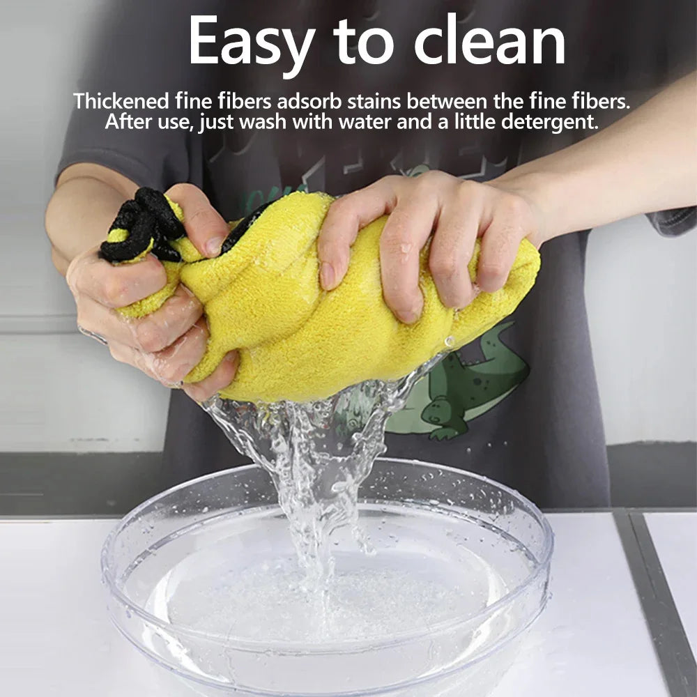 Hands are washing a yellow microfiber towel in a bowl of water to clean stains between the fibers.