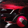 Interior car view showing a portable LED star projector light illuminating the ceiling and a red sphere.