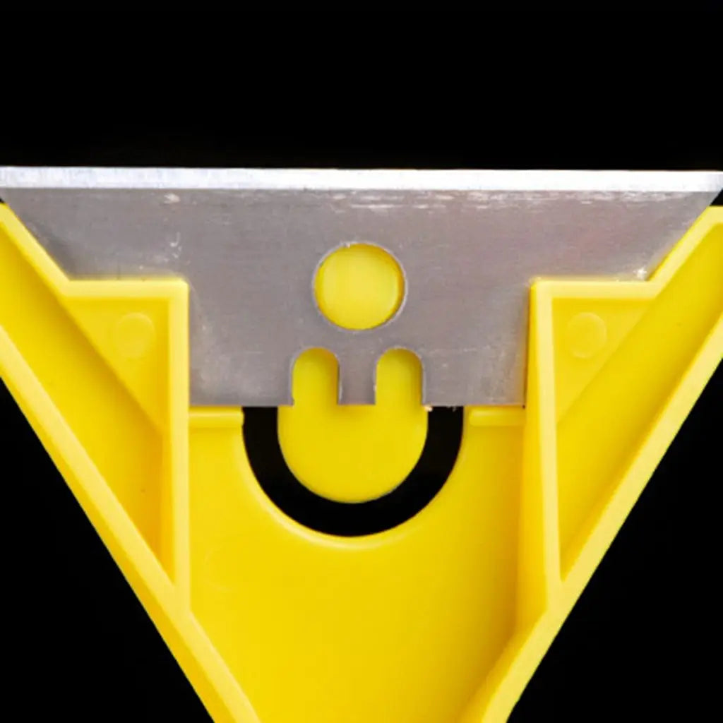 A close-up view of a yellow plastic razor scraper with a silver blade used for cleaning glass or tile surfaces.