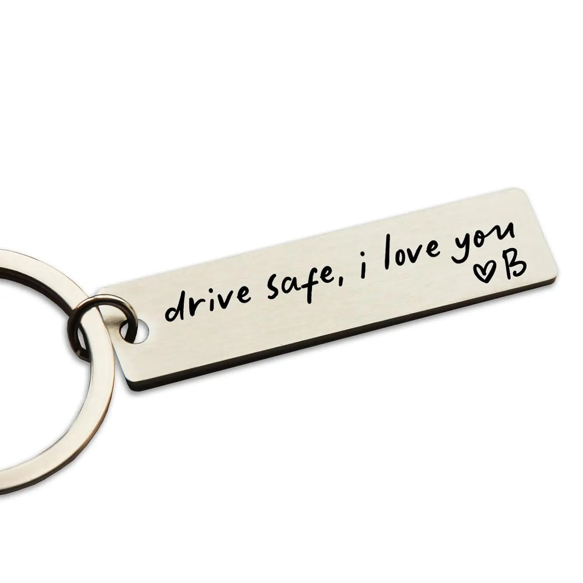 A personalized stainless steel keychain with the engraved message drive safe i love you and a heart symbol.