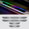 A close-up of a car door sill featuring a colorful LED light strip displaying the word LOGO.
