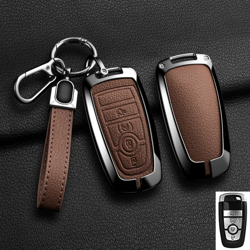A black aluminum alloy key fob cover with a leather strap and keyring is shown against a dark background.
