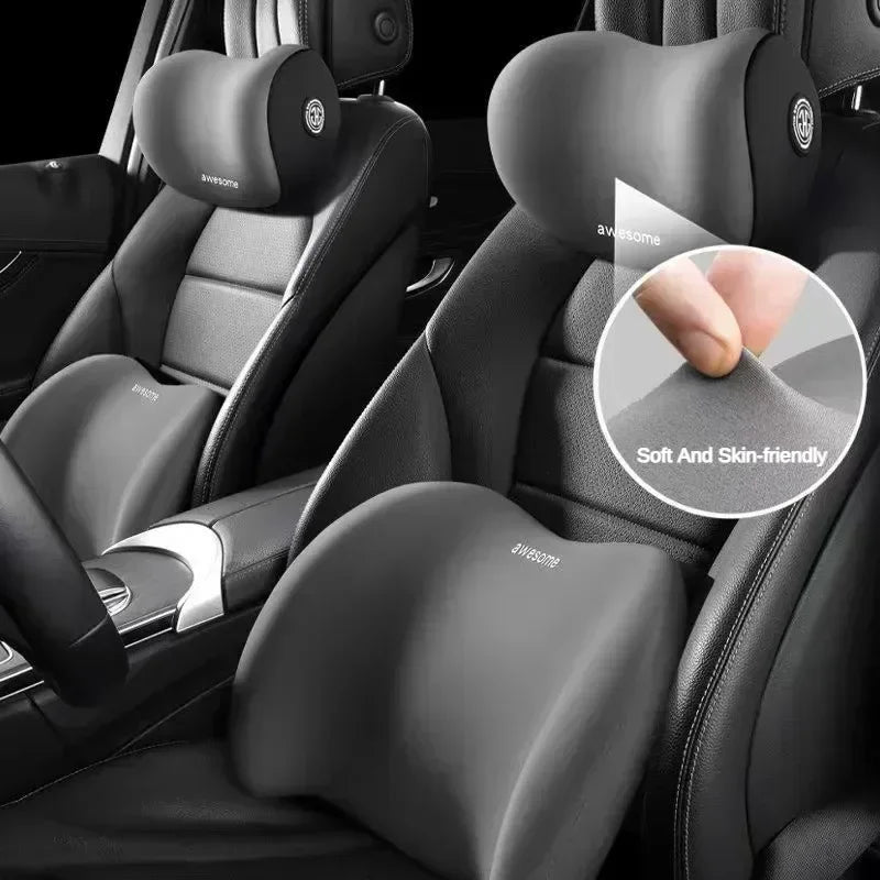 Close-up of a black ergonomic memory foam neck and lumbar pillow set placed in a car seat.