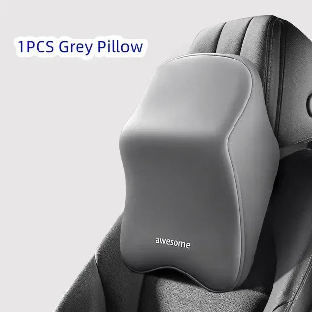 A single grey pillow is shown placed on a car headrest for neck and shoulder support.