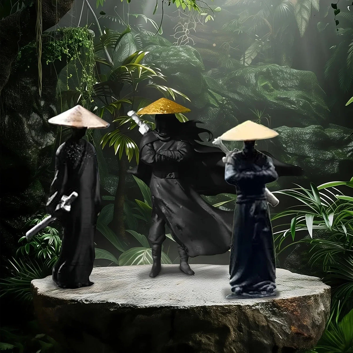 A set of three miniature samurai statues in black and gold armor standing on a rock surface surrounded by lush green foliage.