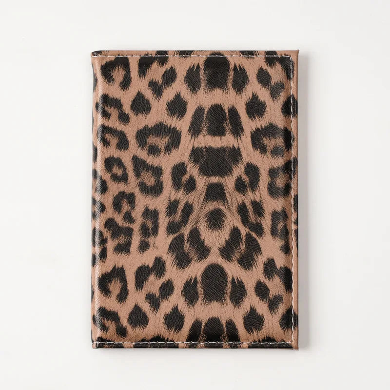 A brown leopard print passport holder with card slots.