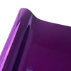 Close-up of a glossy purple vinyl car wrap film showing a curved surface.
