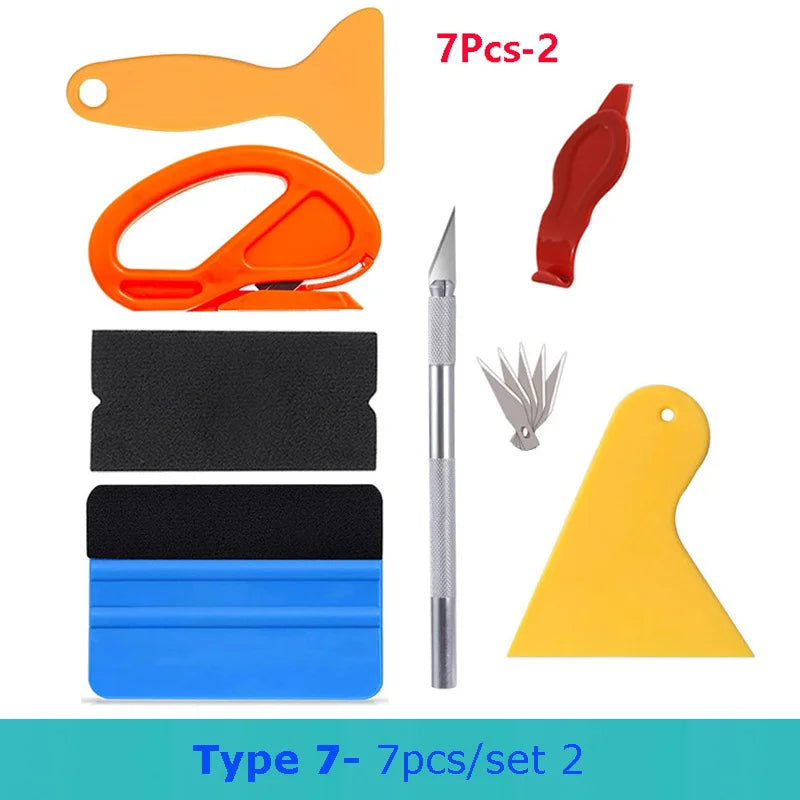 A set of seven professional car vinyl wrapping tools including orange and red tools, a knife, and yellow plastic pieces.