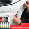 A hand applies Colour Sm pen to repair scratches on a white car surface.