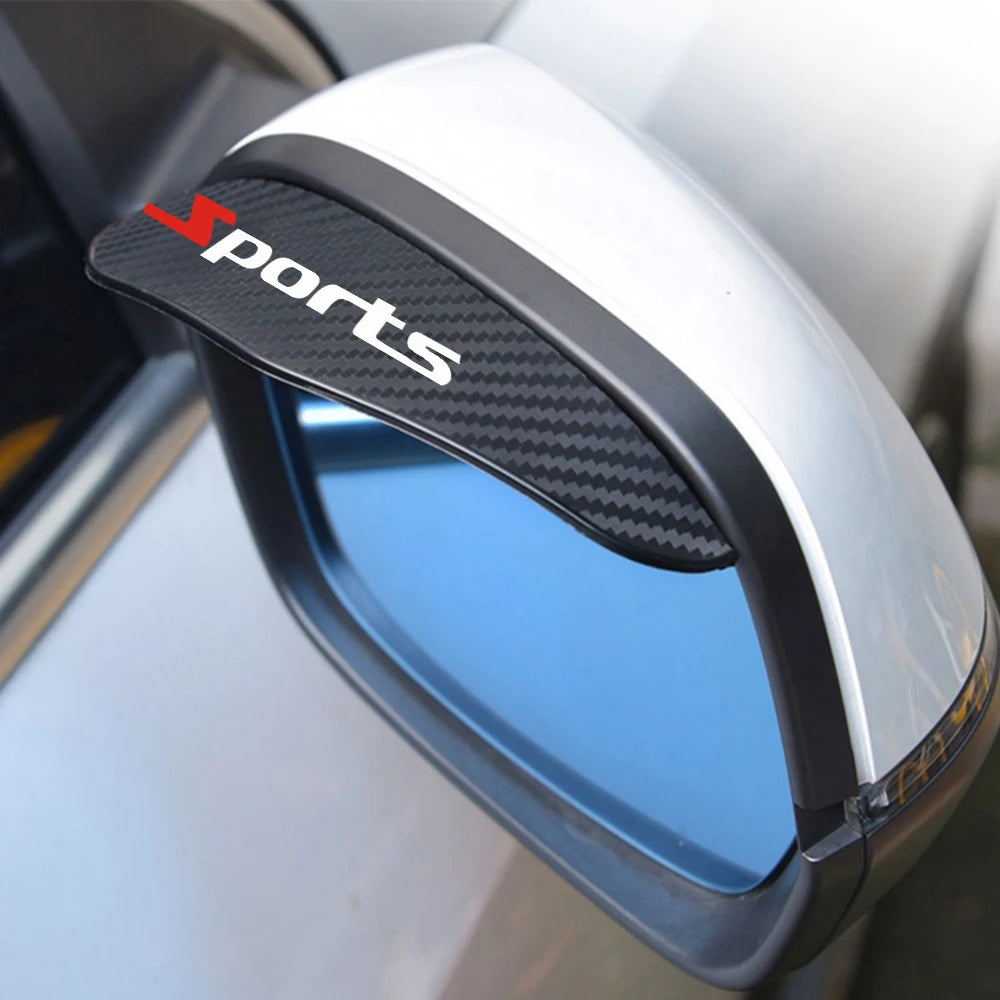 A close-up of a car rearview mirror with a black sports decal and rain protection accessory installed.