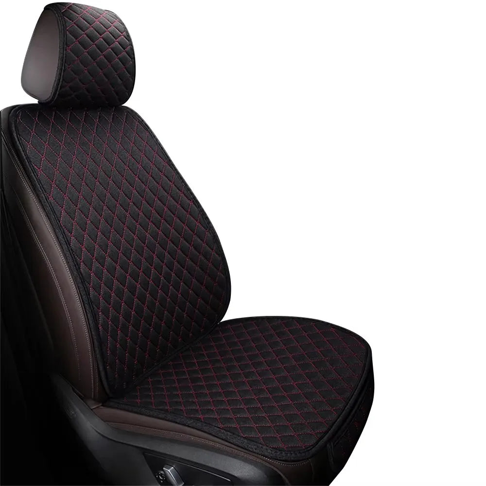 A close-up view of a black car seat with quilted dark brown upholstery and red stitching.