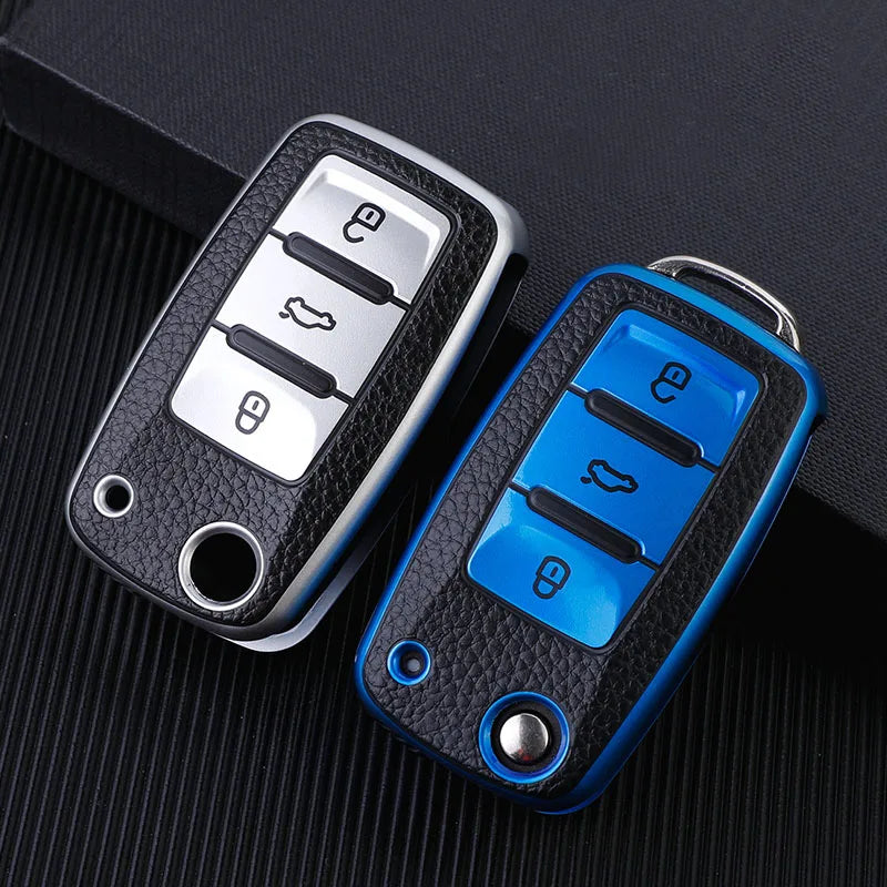 A blue TPU car key fob cover with black buttons is shown against a dark background.