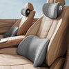 A set of ergonomic memory foam neck and lumbar pillows in beige and gray on a leather seat.