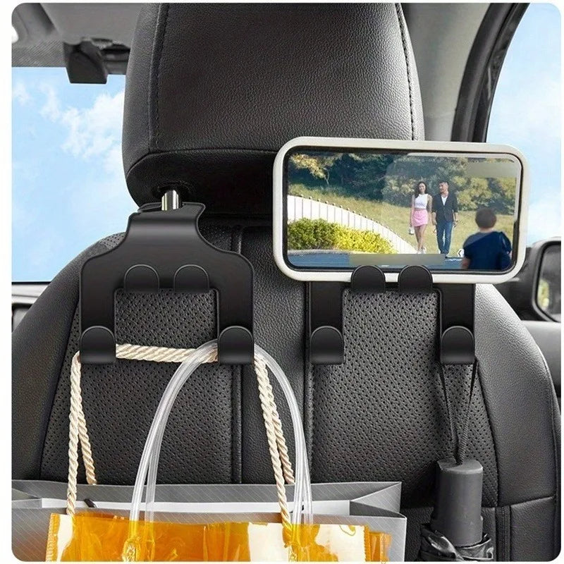 A black universal car seat mobile phone holder with a storage hook is mounted on the seat back.