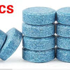 40 pieces of blue effervescent car windshield cleaner tablets stacked and scattered on a white background