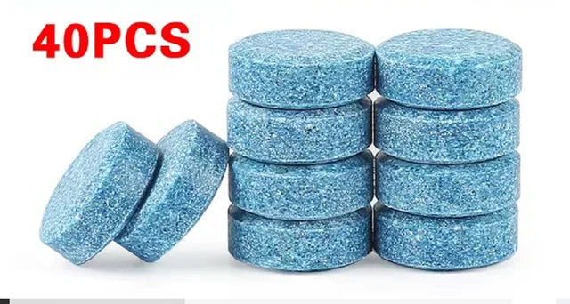 40 pieces of blue effervescent car windshield cleaner tablets stacked and scattered on a white background