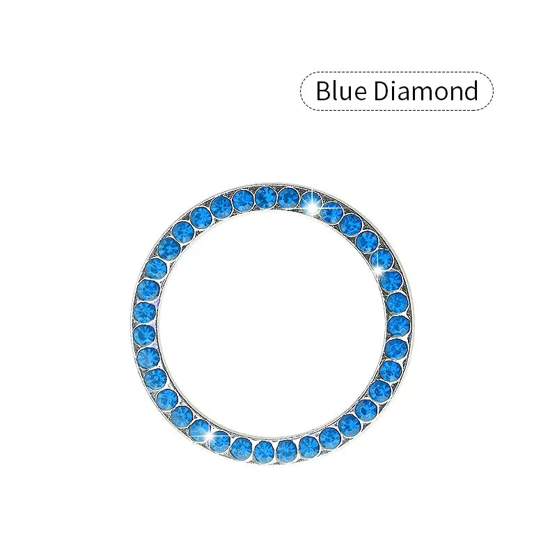 A circular blue diamond decorative ignition push button cover for a car.