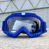 A pair of blue windproof sports goggles with a clear lens resting on a gray surface.