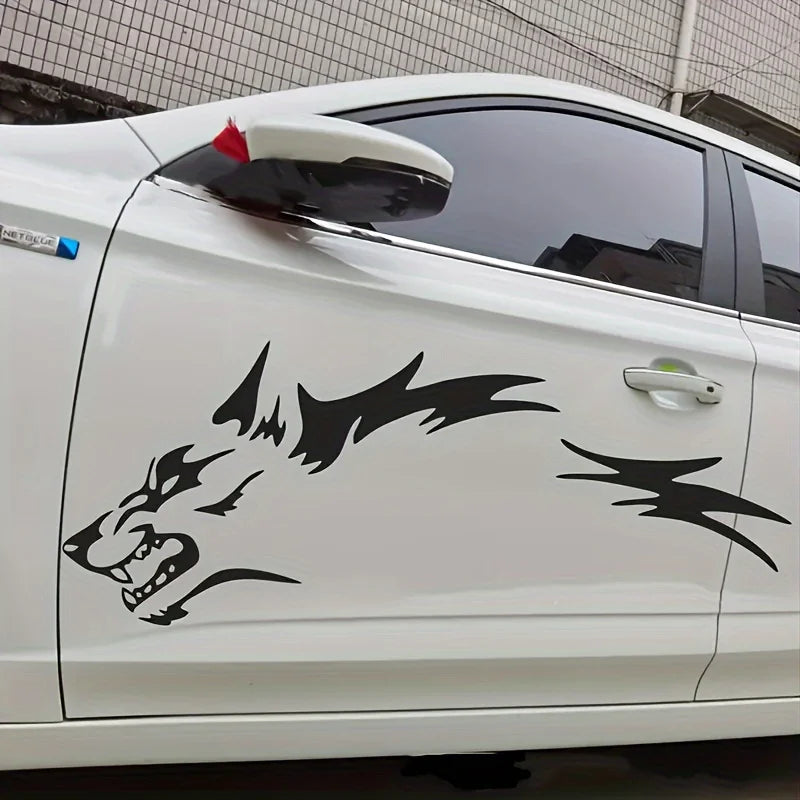 A white car features black wolf decals on the side panel.