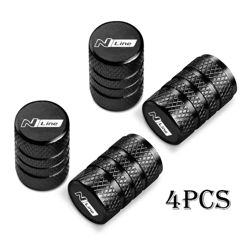A set of four black N Line CNC aluminum tire valve caps shown in various angles.