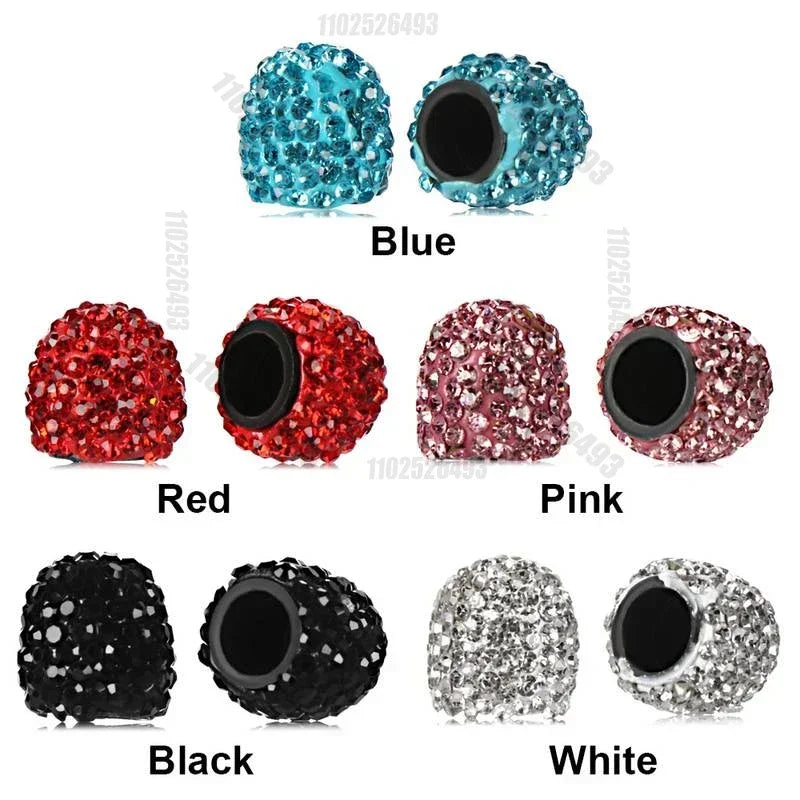 A set of crystal diamond finish tire valve caps in blue, red, pink, black, and white.