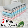 A stack of three reusable glass cleaning cloths in various pastel colors, including light blue, pink, and mint green.