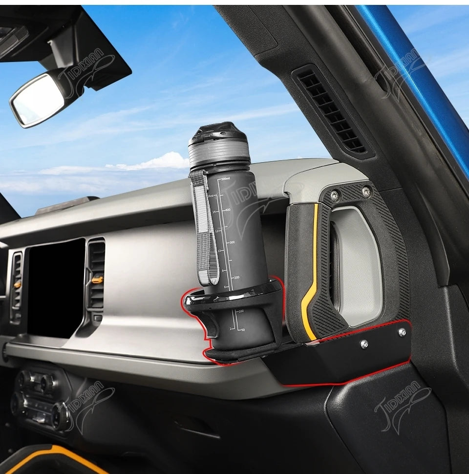 A close-up view of a Ford Bronco A-Pillar handle cup holder with an integrated LED light.