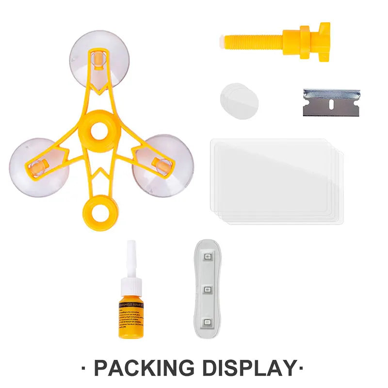 A set of car windshield repair tools including a yellow adhesive dispenser, a metal piece, and a white plastic sheet.
