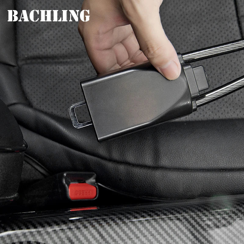 A hand is shown operating a universal car steering wheel and seatbelt anti-theft lock mechanism on a vehicle interior.