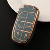 A close-up of a metallic green TPU car key case cover with panic and lock buttons resting on a white plate.