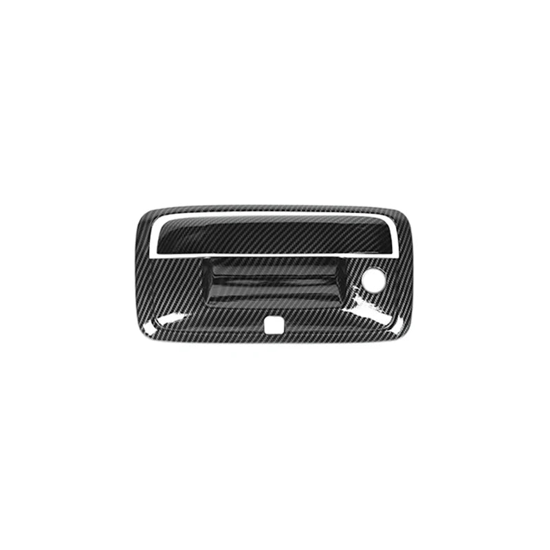 Black textured trim cover for a vehicle tailgate handle.