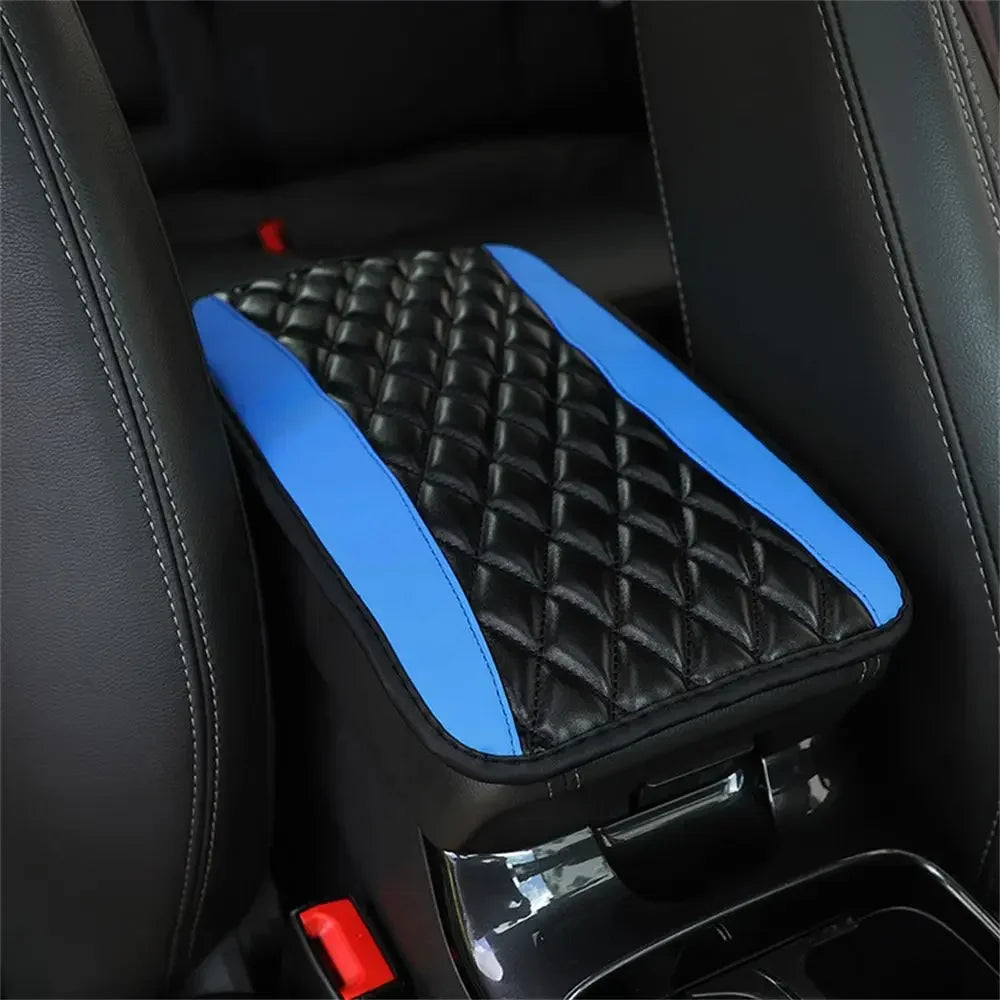 Black and blue quilted armrest protector pad installed in a car interior.